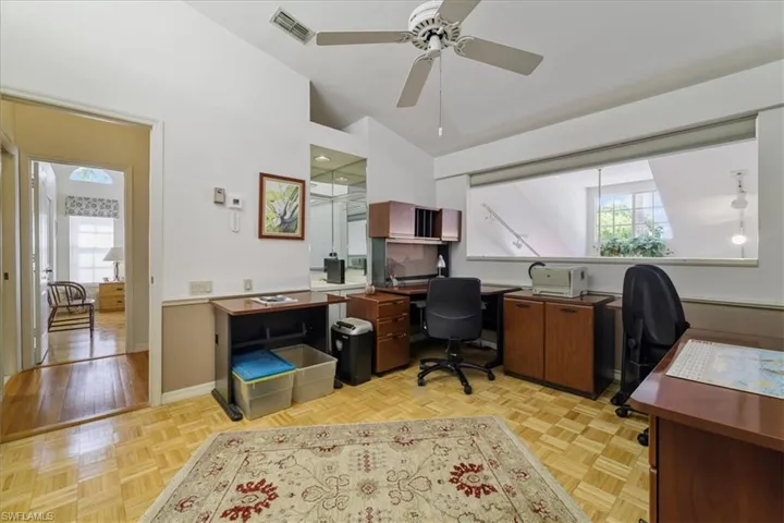 Office featuring healthy amount of natural light, parquet flooring, and ceiling fan