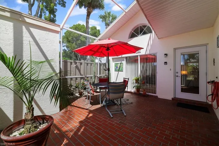 View of patio / terrace featuring glass enclosure, outdoor dining area, and a sunroom