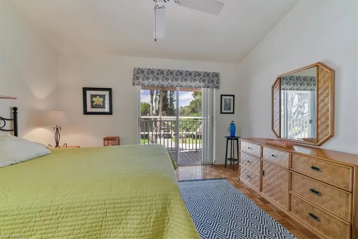 Bedroom with access to exterior, a ceiling fan, and light wood-type flooring