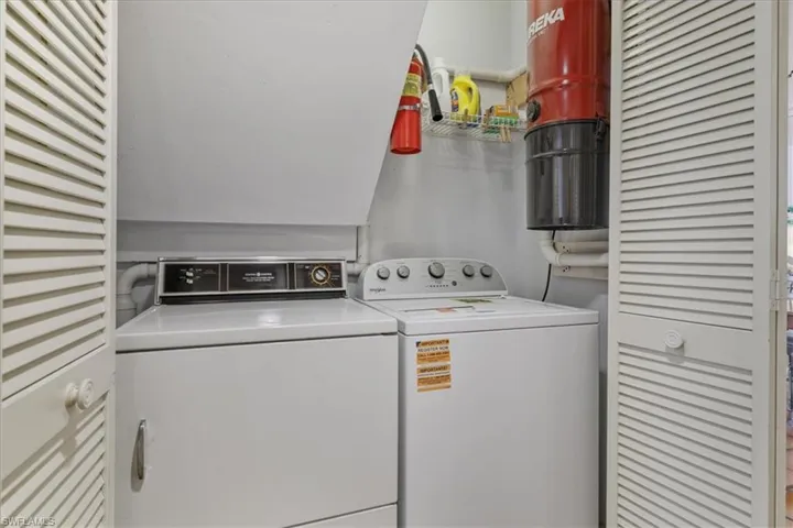 Laundry room with washer and clothes dryer