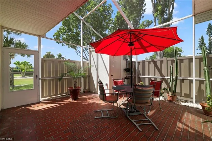 View of patio with a sunroom and glass enclosure