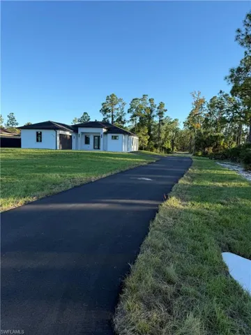 View of front of property featuring a front lawn and stucco siding