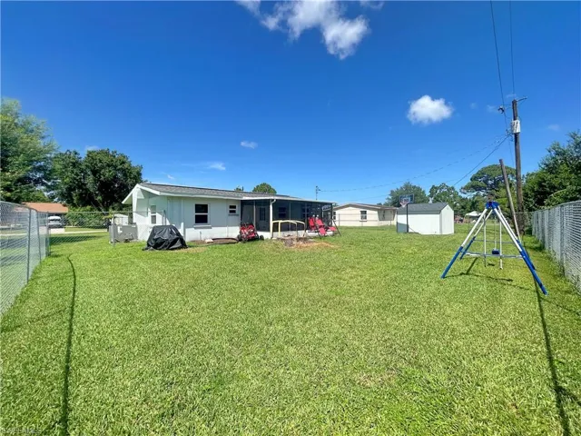 View of yard featuring a shed & fence