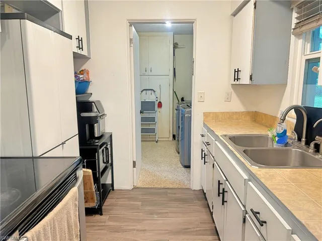 Kitchen featuring sink, wood look tile floors