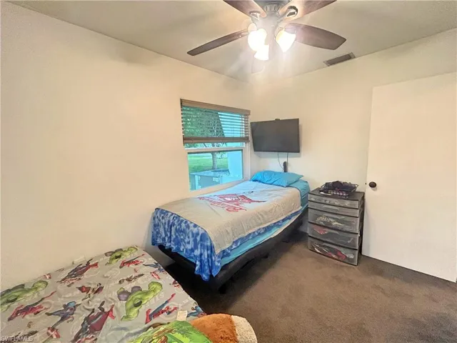 Bedroom featuring ceiling fan and carpet flooring