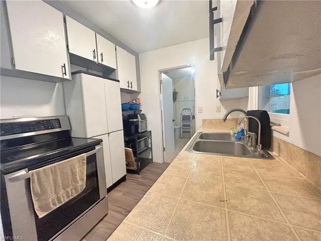 Kitchen featuring sink, wood look tile floors