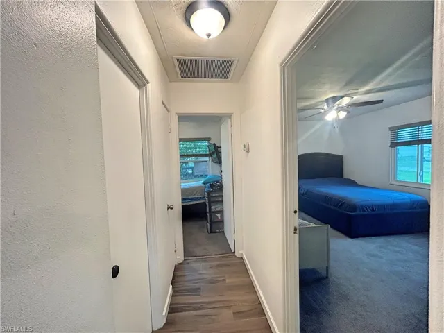 Hallway with wood look tile flooring