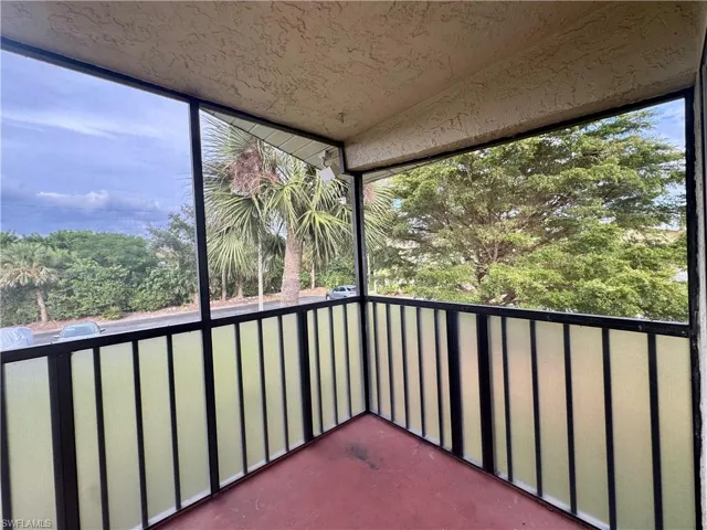 Unfurnished sunroom featuring a balcony