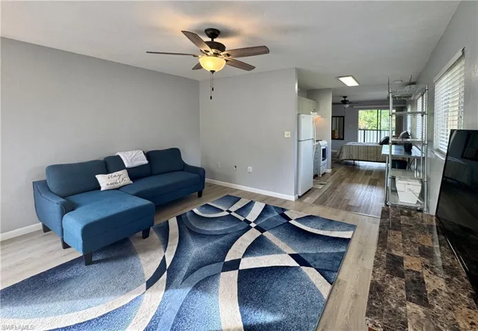 Living area with wood finished floors and a ceiling fan