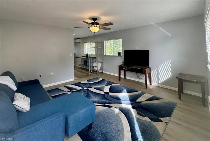 Living room featuring wood finished floors and a ceiling fan