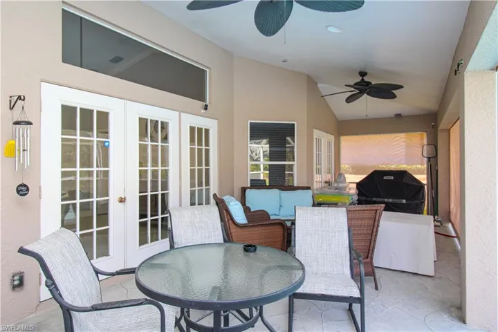 View of patio featuring ceiling fan, french doors, grilling area, and outdoor dining space