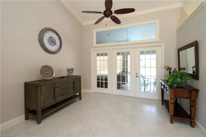Doorway to outside featuring a ceiling fan, french doors, baseboards, and ornamental molding