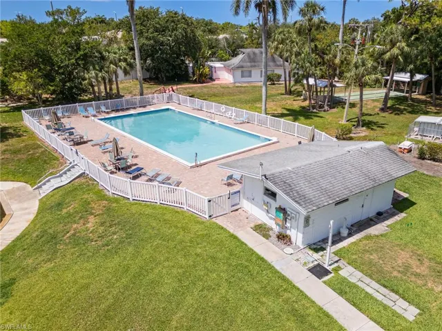 Community pool with view of Clubhouse and Shuffle Board Courts.
