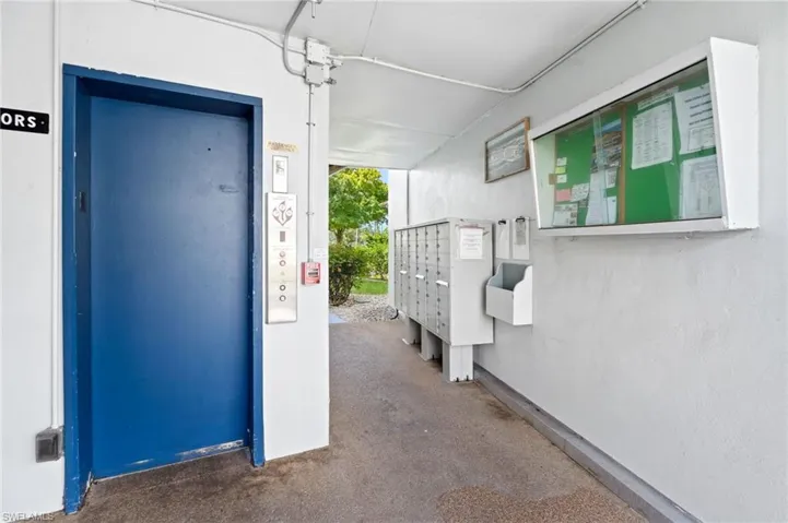View of exterior entry featuring elevator and mailboxes