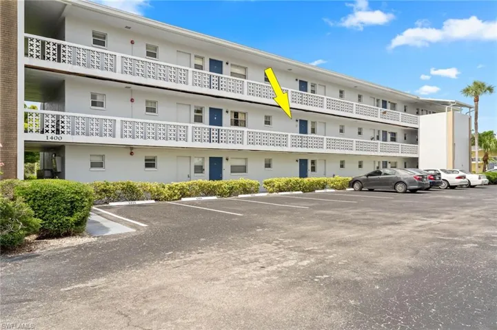 View of building exterior with parking