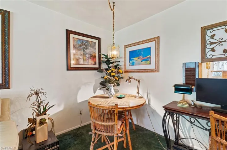 Dining space with baseboards and dark carpet
