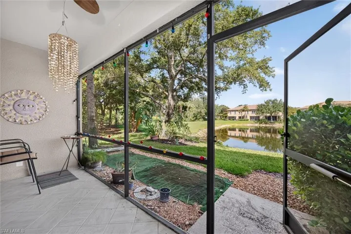 Screened patio featuring ceramic tile flooring and a ceiling fan