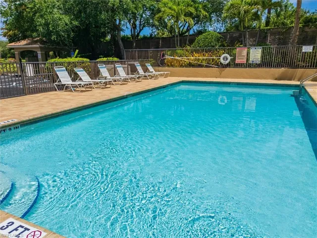 Outdoor swimming pool with integrated steps, surrounded by a paved deck