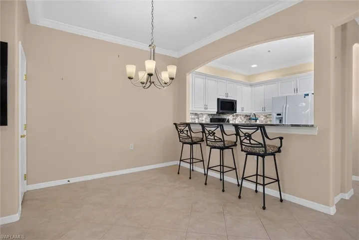 Kitchen pass-through with a stone countertop and seating for three