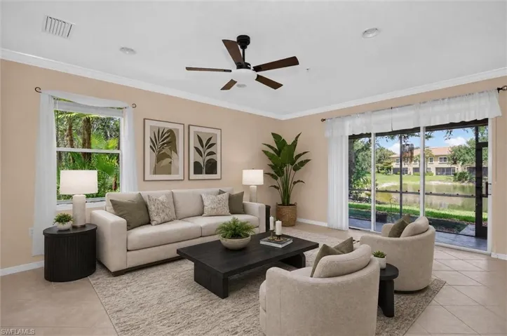 Living area featuring neutral wall tones, crown molding, and tiled flooring