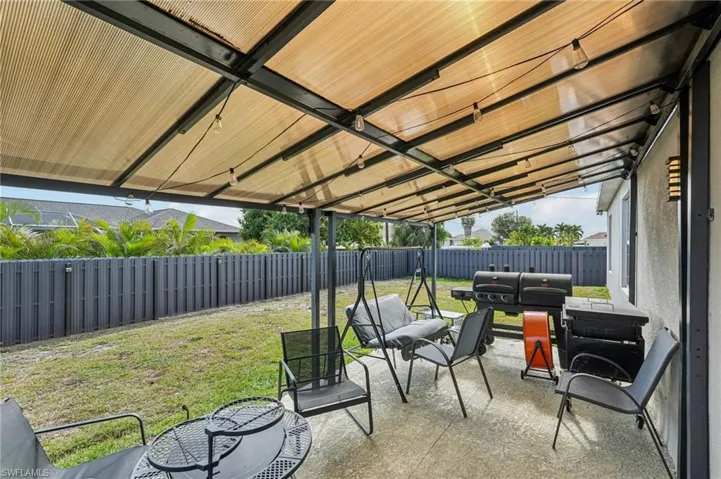 Fenced backyard featuring a patio and an outdoor living space