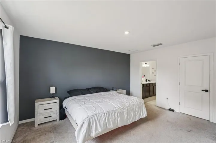 Carpeted bedroom with ensuite bathroom