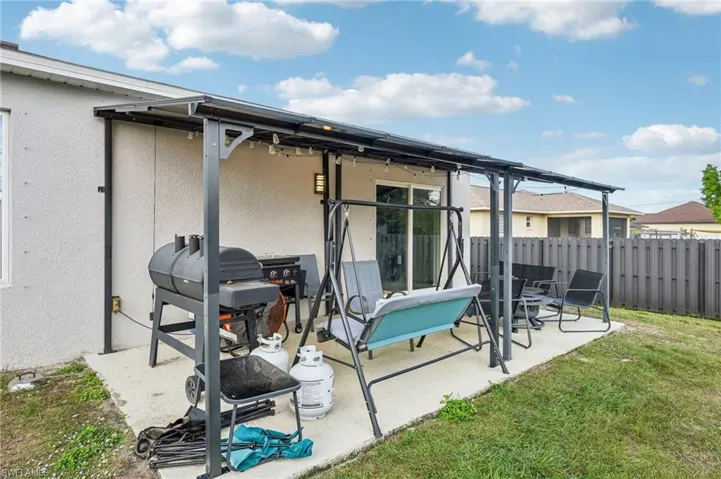 Rear view of property with stucco siding and a patio