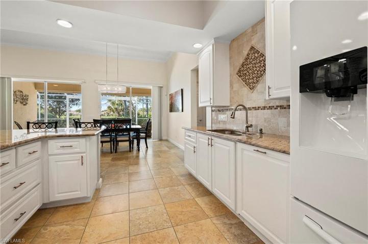 28353 Moray Dr Bonita Springs FL 34135 - White kitchen with drawers in lieu of doors on peninsula