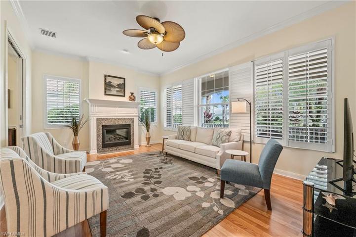 28353 Moray Dr Bonita Springs FL 34135 - Living room with pocket door access to Den, and fireplace