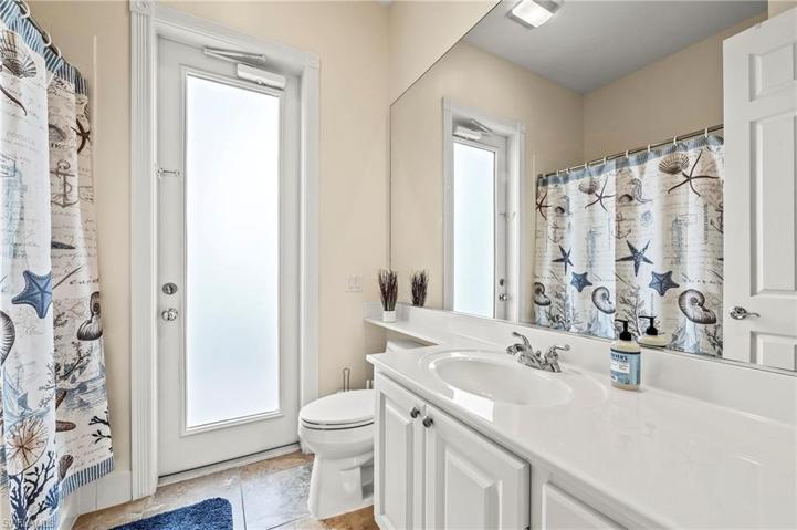 28353 Moray Dr Bonita Springs FL 34135 - Pool bath is located on the guest wing and has a frosted glass window for additional light.