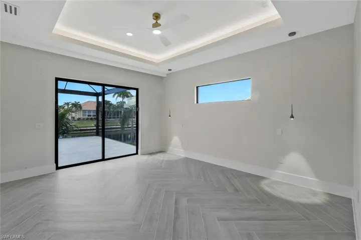 Spare room with healthy amount of natural light and a raised ceiling