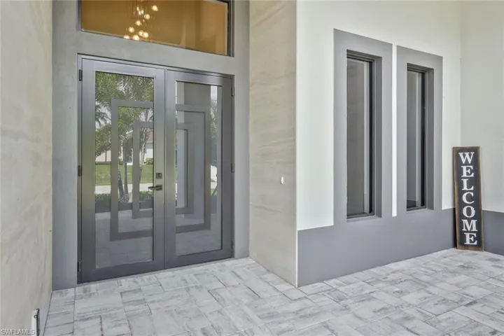Doorway to property with french doors and stucco siding