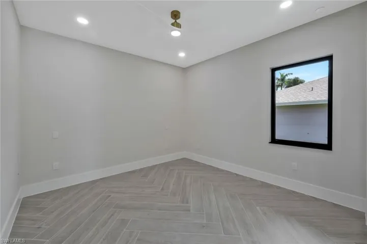Spare room featuring baseboards and recessed lighting