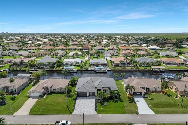 Aerial perspective of suburban area with a large body of water