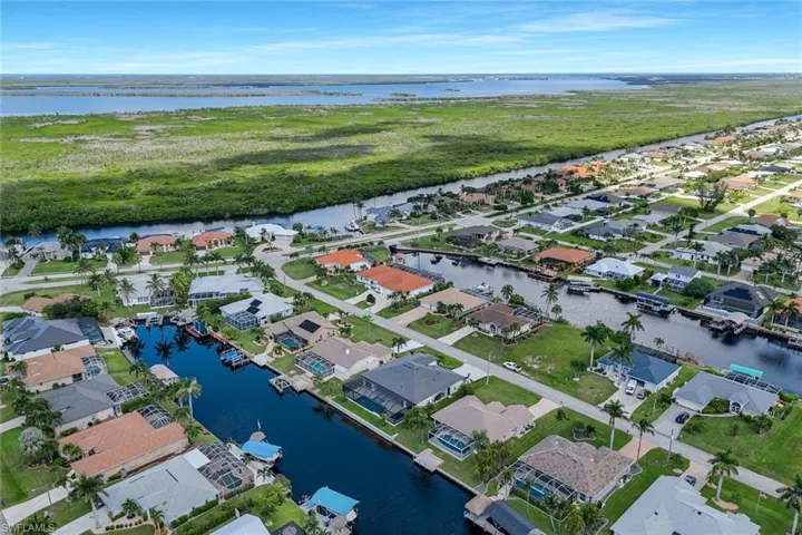 View of property location with a large body of water and nearby suburban area