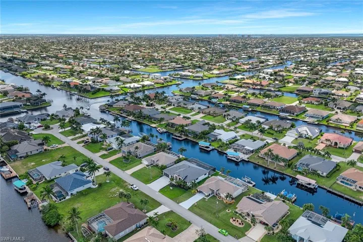Aerial perspective of suburban area featuring a large body of water