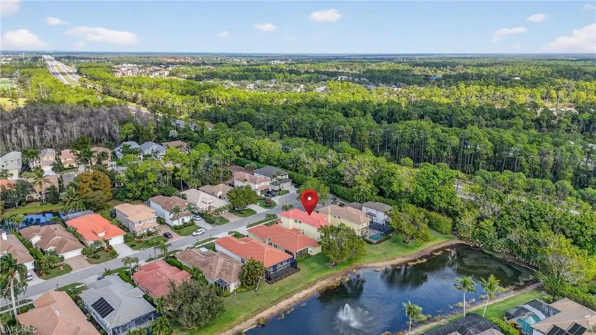 Aerial view of property's location with a lake