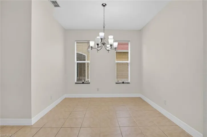 Dining area featuring a chandelier and light tile patterned floors