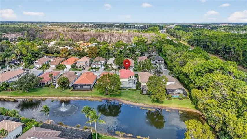 Aerial view of property's location with a large body of water and nearby suburban area