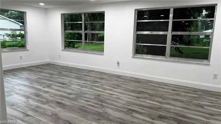 Empty room with baseboards and wood finished floors