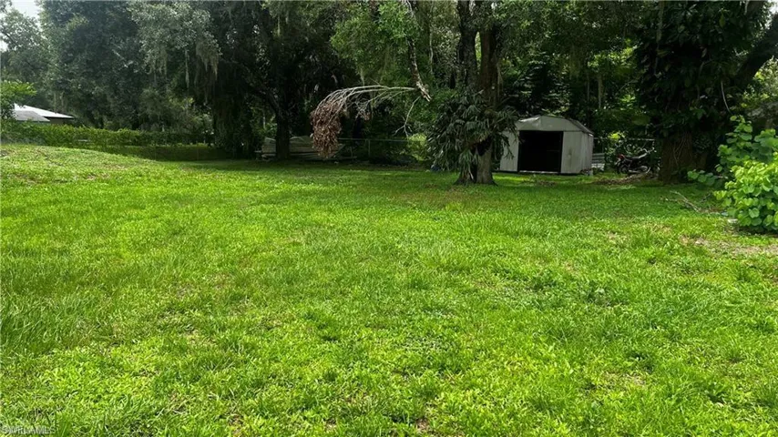 View of yard featuring an outdoor structure and a storage shed