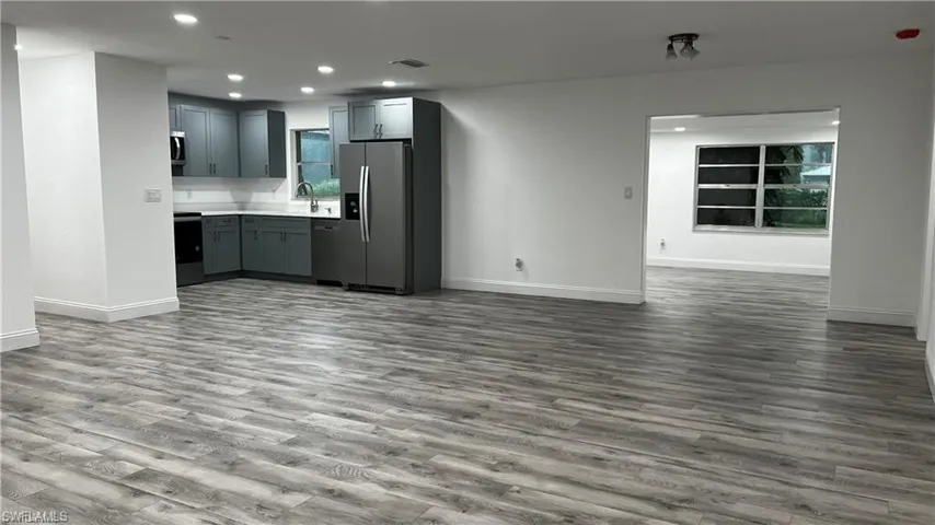 Kitchen with open floor plan, light countertops, recessed lighting, stainless steel appliances, and visible vents