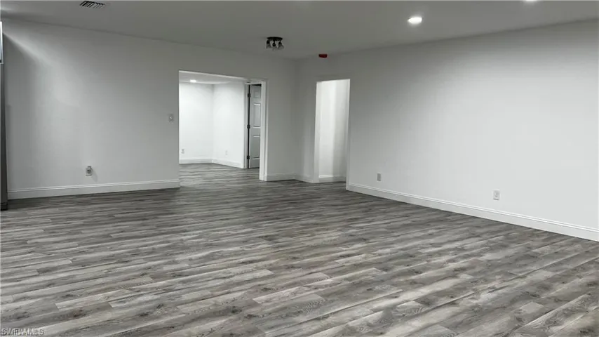 Unfurnished room featuring recessed lighting, baseboards, and wood finished floors