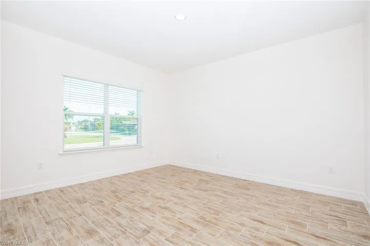 Spare room featuring wood finish floors