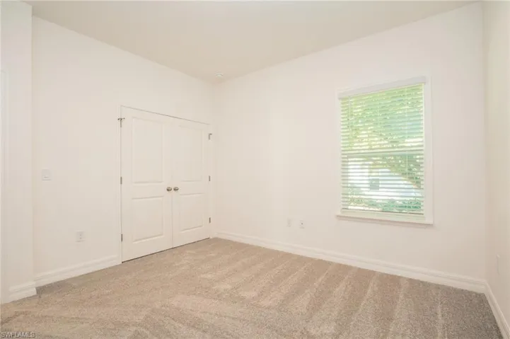 Unfurnished bedroom with carpet floors and a closet