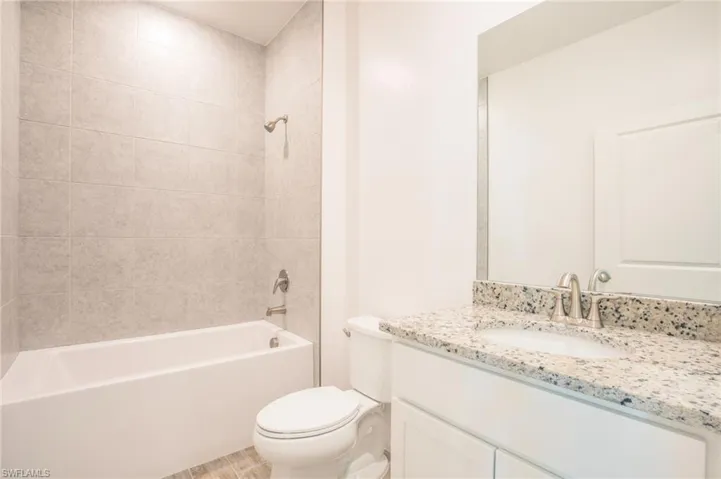 Bathroom with shower / bath combination and vanity