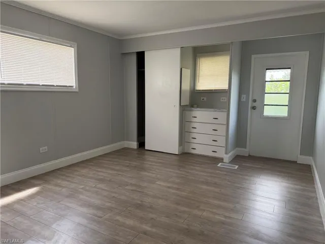 Guest Bedroom with built-in dresser and back door access