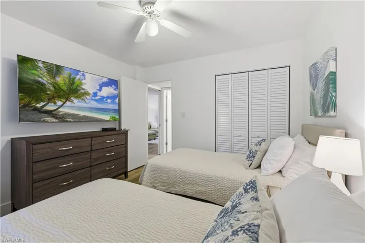 Bedroom with a closet, ceiling fan, and wood finished floors
