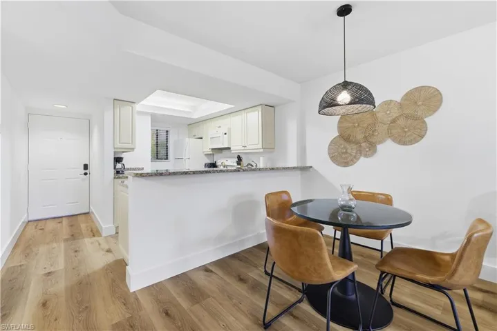 Dining room with light wood-style floors and baseboards