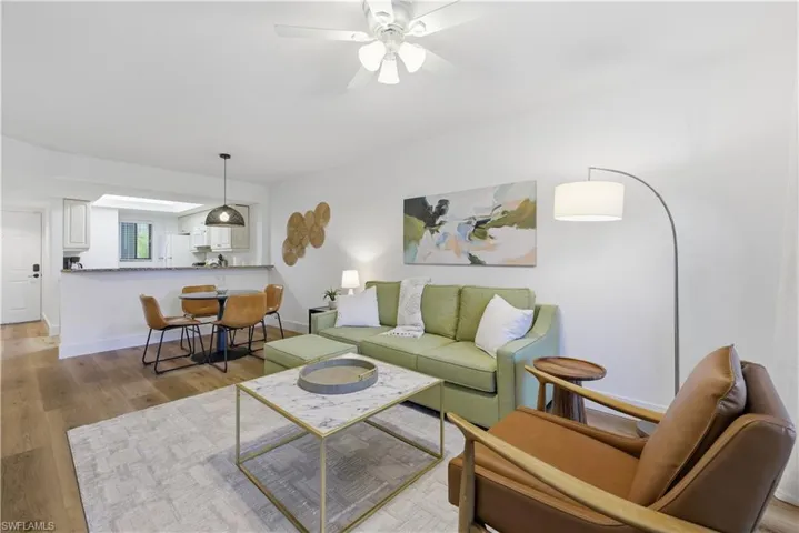 Living area with light wood-style flooring and a ceiling fan